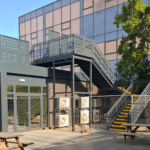 A building with a staircase and a tree